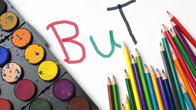 Farbkasten, Buntstifte und Schriftzug "BuT"